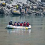 a group of people riding on the back of a white boat